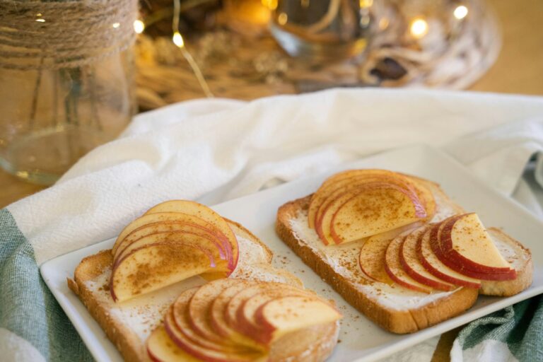 a white plate topped with slices of bread covered in apple slices